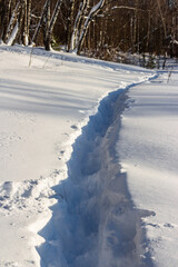 Obraz premium Well-trodden path through deep snow, winter landscape