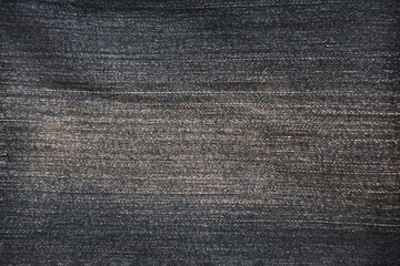 Black denim jeans texture with horizontal longitudinal thread lines         