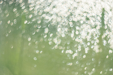 Creative background image, light transparent drops of water in blur. Blurred bokeh on light background.