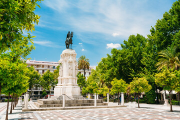 Monument to King Saint Ferdinand at New Square Plaza Nueva) in Seville, Spain. - obrazy, fototapety, plakaty