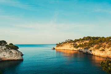 Calanques, Cote de Azur, France. Beautiful nature of Calanques on the azure coast of France. Calanques - a deep bay surrounded by high cliffs. Landscape in sunrise light during Sunny summer morning - obrazy, fototapety, plakaty