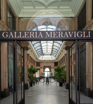Art Nouveau gallery with luminous glass and wrought iron roof, the floor is made with mosaics with floral decorations.Galleria Meravigli 1928, Milan, Italy.