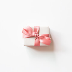 White gift box with pink ribbon isolated on white background. top view, copy space