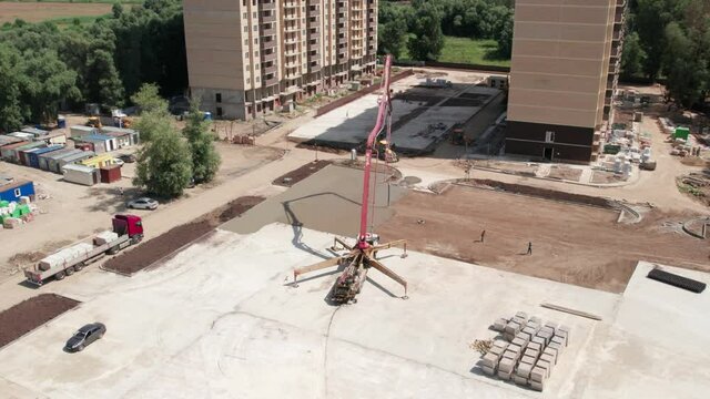 Aerial view - road construction site and a big pump for concrete pouring road