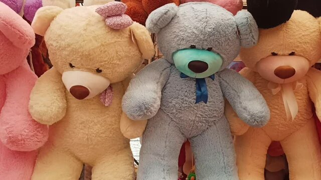 Lots of big multicolored teddy bears in the store. Panorama. Happy childhood, favorite toys