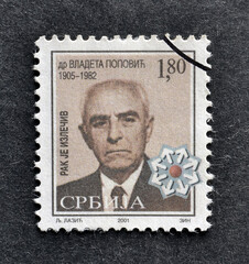 Cancelled postage stamp printed by Serbia, that shows md Vladeta Popovic, promoting Fight against...