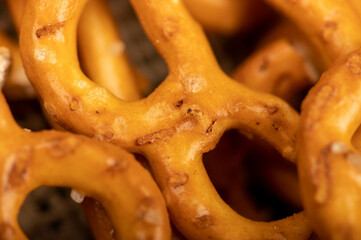 Crispy bread straws with salt, close-up, selective focus, top view.