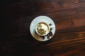 Coffee cup and coffee beans on white table.