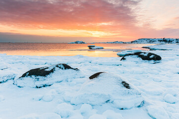 Fototapeta na wymiar Snow covered coastal scene at sunset