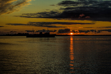 Military ship on the background of the sunset