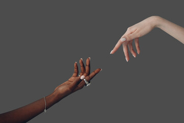 World Humanitarian Day. Caucasian white and African American black hand reaching out to each other...