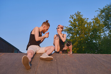 Portrait of cute couple smoking outdoors