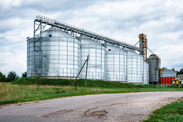 Fototapeta na wymiar Dairy factory. Large cisterns of metallic color outdoors.