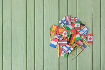 Flags of different countries on wooden background