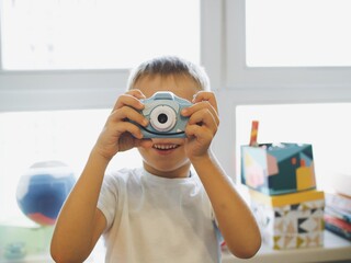 
children play with a toy camera. take pictures