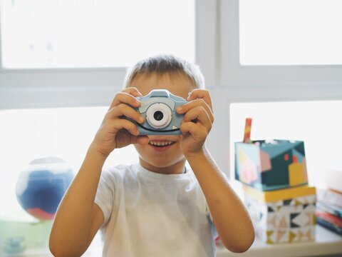 
children play with a toy camera. take pictures