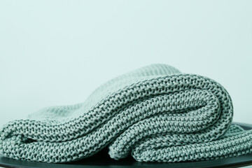Knitted plaid on color background, closeup