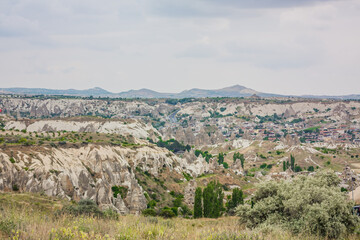 Fototapeta na wymiar Amazing Volcanic rock formations known as Love Valley or Fairy Chimneys in Cappadocia, Turkey. Mushroom Valley one of attractions in Goreme National Park, Turkey. Mountains with rooms inside