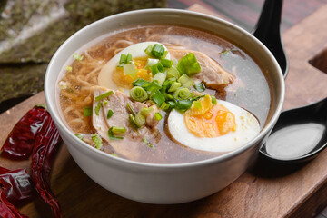 Tasty Chinese soup with chicken in bowl on table, closeup