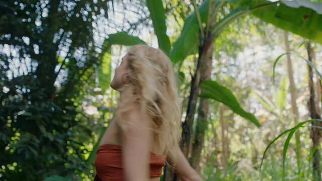 beautiful woman walking in forest dancing enjoying natural beauty exploring lush tropical jungle alone 4k