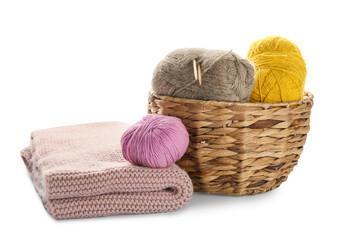 Fototapeta na wymiar Wicker basket with knitting yarn and plaid on white background