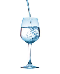pouring water into wine glass isolated on white background
