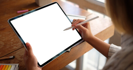 Designer woman working with digital tablet in creative office.