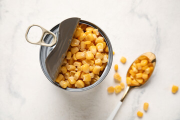 Tin can with corn kernels on light background, closeup