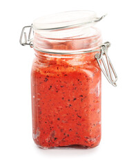 Jar of tasty pesto sauce on white background