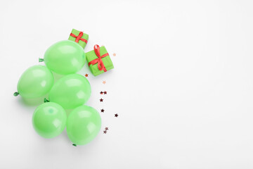 Gift boxes and air balloons on light background