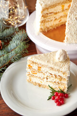 Slice of cake with coconut and peaches decorated for Christmas.