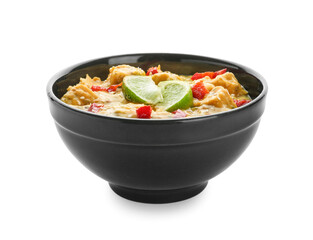 Bowl of tasty chicken curry on white background