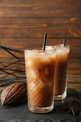 Glasses of tasty chocolate milk on table, closeup