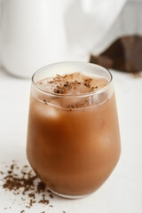Glass of tasty chocolate milk on light background, closeup