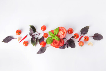 Fresh basil, garlic, tomato and chili pepper on white background