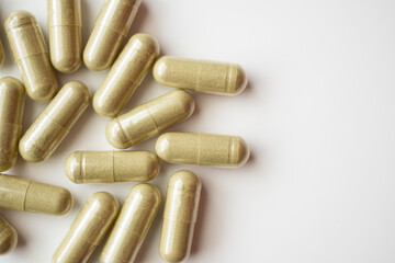 Herbal medicine capsules on white background