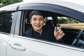 man with smart key remote in a car