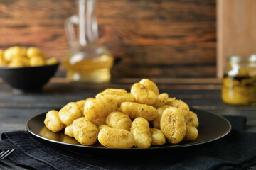 Plate with tasty pesto gnocchi on table