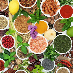 Herbs and spice background collection of fresh and dried seasoning ingredients. Healthy eating in porcelain bowls. High in antioxidants, vitamin c, lycopene, anthocyanins. Flat lay. 