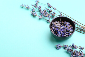 Obraz na płótnie Canvas Bowl with lavender flowers on color background