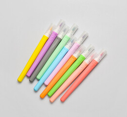 Colorful markers on light background