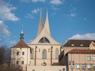 Obraz premium Benedictine monastery Emauzy, frontal view. Architectural monument from fourteen century with two modern spiky towers on sunny day, Prague, Czech Republic