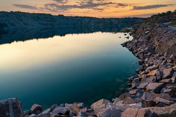 Fototapeta na wymiar Small lake surrounded by stone waste from mine work