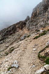 Hiking trail near Passo delle Coronelle in Dolomites mountains in Italy