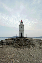 Fototapeta na wymiar beautiful lonely lighthouse with mountains in the background