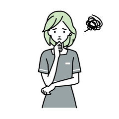 立って手をあごにあてて困っているエステ店員の女性