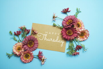Happy Thursday typography text with flowers on pink background
