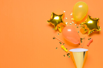 Party hat, balloons, candles and confetti on color background