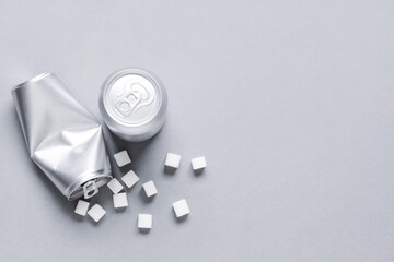 Cans of soda and sugar on grey background. Diabetes concept