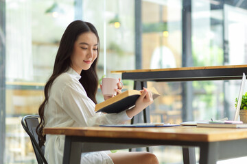Attractive woman enjoy reading book and drinking coffee